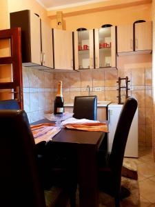 a kitchen with a table with a bottle of wine on it at Apollon home apartments in Bar