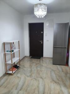 um quarto com uma porta preta e um frigorífico em Christine em Târgu Jiu