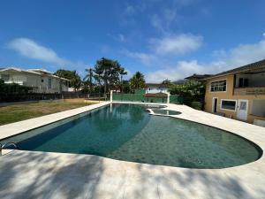 a swimming pool in the yard of a house at Casa Condominio Barra de Juquehy in Juquei