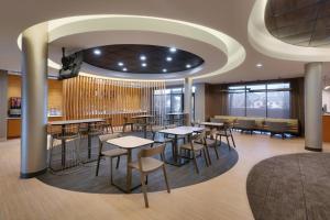 a restaurant with tables and chairs in a room at SpringHill Suites by Marriott Provo in Provo