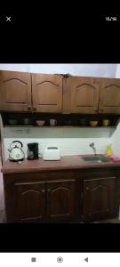 a kitchen counter with a sink and wooden cabinets at Carmelo in Carmelo