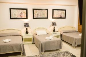 Ένα ή περισσότερα κρεβάτια σε δωμάτιο στο HOTEL OBREGON