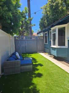 a backyard with a couch sitting on the grass at Entire home in Historic Long Beach close to shops in Long Beach
