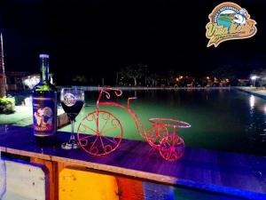 a bottle of wine and a bike with a glass at Villa Kerly Hotel en La Unión Valle in Lemos