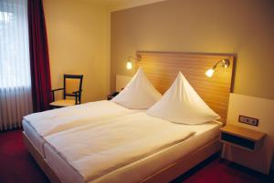 Postel nebo postele na pokoji v ubytování Hotel Mühleneck