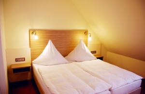 Postel nebo postele na pokoji v ubytování Hotel Mühleneck