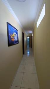 a hallway in a building with a painting on the wall at Fabika Pousada in Maragogi