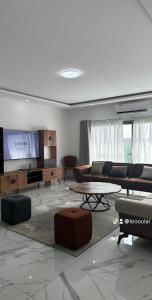 a living room with a couch and a table at Residence Roume Abidjan Plateau in Abidjan