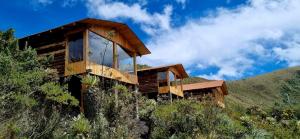 a house on the side of a hill at Espeletia Lodge in El Ángel