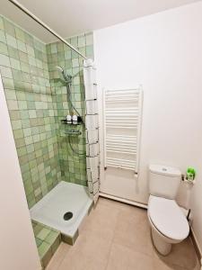 a bathroom with a toilet and a shower at CHARMING APARTMENT WITH PANORAMIC SEINE RIVER & EIFFEL TOWER VIEWs in Ivry-sur-Seine +23 photos