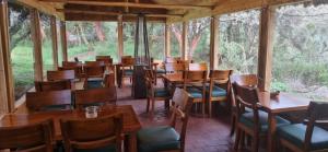 a dining room with wooden tables and chairs at Espeletia Lodge in El Ángel