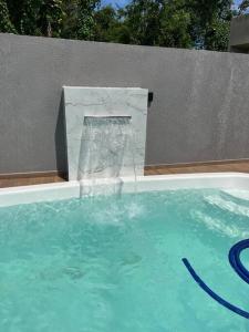 a water fountain in a swimming pool at Casa Esmeralda in Guaratuba