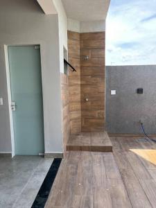 a room with a door and a wooden floor at Casa Esmeralda in Guaratuba