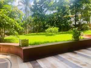 a bench in a park with a green field at Residence Roume Abidjan Plateau in Abidjan