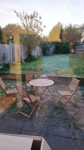 a table and four chairs in a backyard with a table at House in Great Barr, with parking and garden in Birmingham