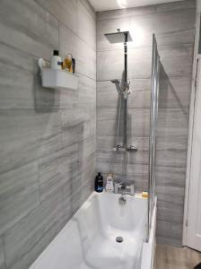 a white bathroom with a shower and a sink at House in Great Barr, with parking and garden in Birmingham
