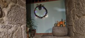 a wreath on the wall of a room with pumpkins at Casa do Crego in Vilaboa