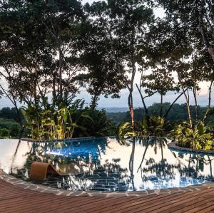 a swimming pool with trees in the background at Hotel Boutique Maitta en Doradal Antioquia in Doradal