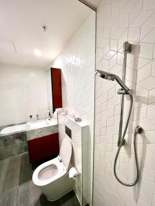 a bathroom with a toilet and a sink and a shower at Sydney Cosmopolitan CBD Apartment in Sydney