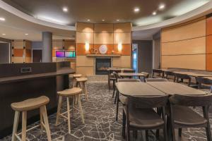 a restaurant with tables and chairs and a fireplace at SpringHill Suites by Marriott Yuma in Yuma
