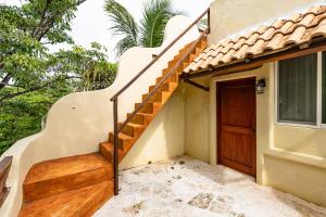 a staircase leading up to a house with a door at Villas Xaguar by PlayaSky in Playa del Carmen