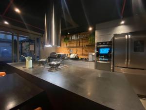 a kitchen with stainless steel appliances and a counter at RioDowntown - Rede Nosso Cantinho in Rio de Janeiro