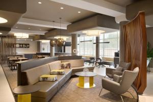a lobby with a couch and chairs and tables at SpringHill Suites Ewing Township Princeton South in Ewing