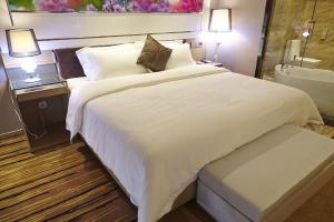 Voodi või voodid majutusasutuse Lavande Hotel Zhanjiang Guomao toas