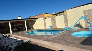 a swimming pool with a slide in a building at Casa con piscina y barbacoa in Rivera