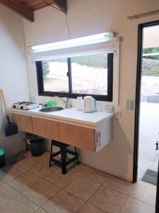 a kitchen counter with a sink and a window at Mina's Apart in Mina Clavero