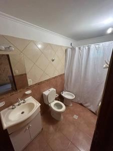 uma casa de banho com um WC e um lavatório em Urú em Puerto Iguazú