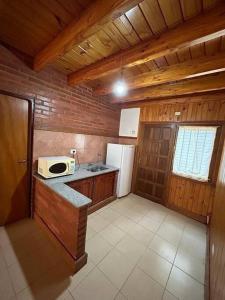 a kitchen with a counter and a microwave in it at Urú in Puerto Iguazú