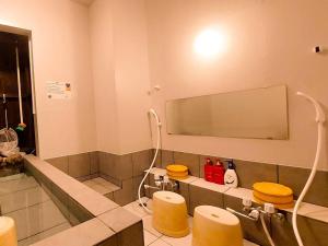 a bathroom with two toilets and a large mirror at DAVID NO YAKATA - Vacation STAY 16849v in Yufuin