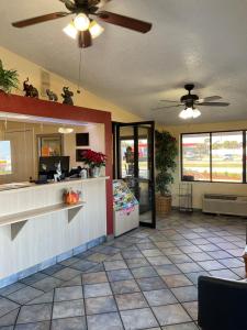 a lobby of a restaurant with a counter and a kitchen at Knights Inn Punta Gorda in Punta Gorda