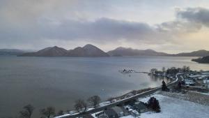 a view of a large body of water with mountains at LAKE TOYA Logde SIGRA in Lake Toya