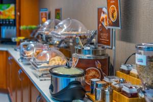 una línea de buffet con comida en un mostrador en SpringHill Suites Statesboro University Area, en Statesboro