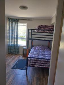 a bedroom with two bunk beds and a window at Departamento Playa Pto Montt in Puerto Montt