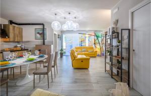 a living room with a table and a yellow couch at Beautiful Home In Marotta With Kitchen in Marotta