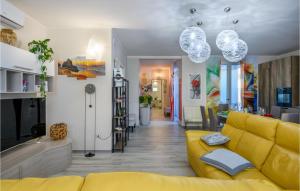 a living room with a yellow couch and a yellow chair at Beautiful Home In Marotta With Kitchen in Marotta