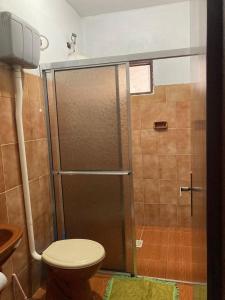 ein Badezimmer mit Dusche und Toilette in der Unterkunft Casa na Praia, Torres RS in Torres