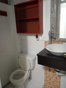 a bathroom with a toilet and a sink at EDIFICIO MARIA KIAN in San Bartolo