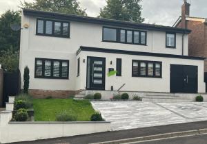 een wit huis met zwarte luiken bij Large NEW Detached House Woolton, Families, FREE Parking, Massage, BBQ, Play room & MORE in Woolton