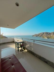 a room with a large window with a view of the ocean at Hotel TNT Mirador in Taganga