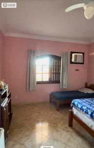 a bedroom with a bed and a window and a bed sidx sidx sidx at Casa em Saquarema in Saquarema
