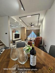 a bottle of wine sitting on a table in a living room at Traveller's stay for 10 pax in Ipoh