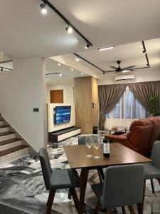 a living room with a table and chairs at Traveller's stay for 10 pax in Ipoh