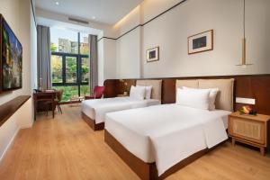 Posteľ alebo postele v izbe v ubytovaní Wuyu Hotel, Smart Park & Happy Valley Jinshansi Metro