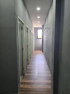 a hallway with a row of stalls in a building at No 9 HOUSE Hua Hin in Khao Tao