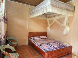 - une petite chambre avec un lit à baldaquin dans l'établissement Vạn Duy Homestay, à Quản Bạ