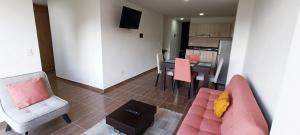 a living room with a couch and chairs and a table at Apartamento para descansar 3 in Paipa